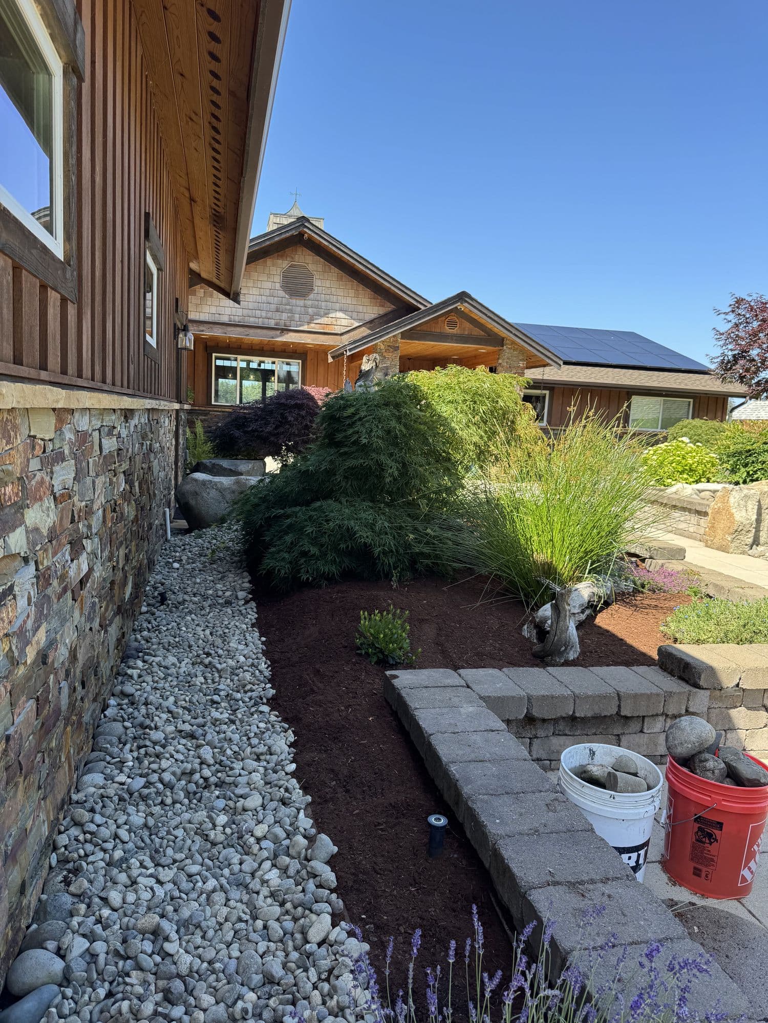 Paver walkway, stone steps, and mulch beds installed by Salazar Landscaping